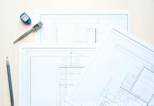 Architectural blueprint on a table with construction tools